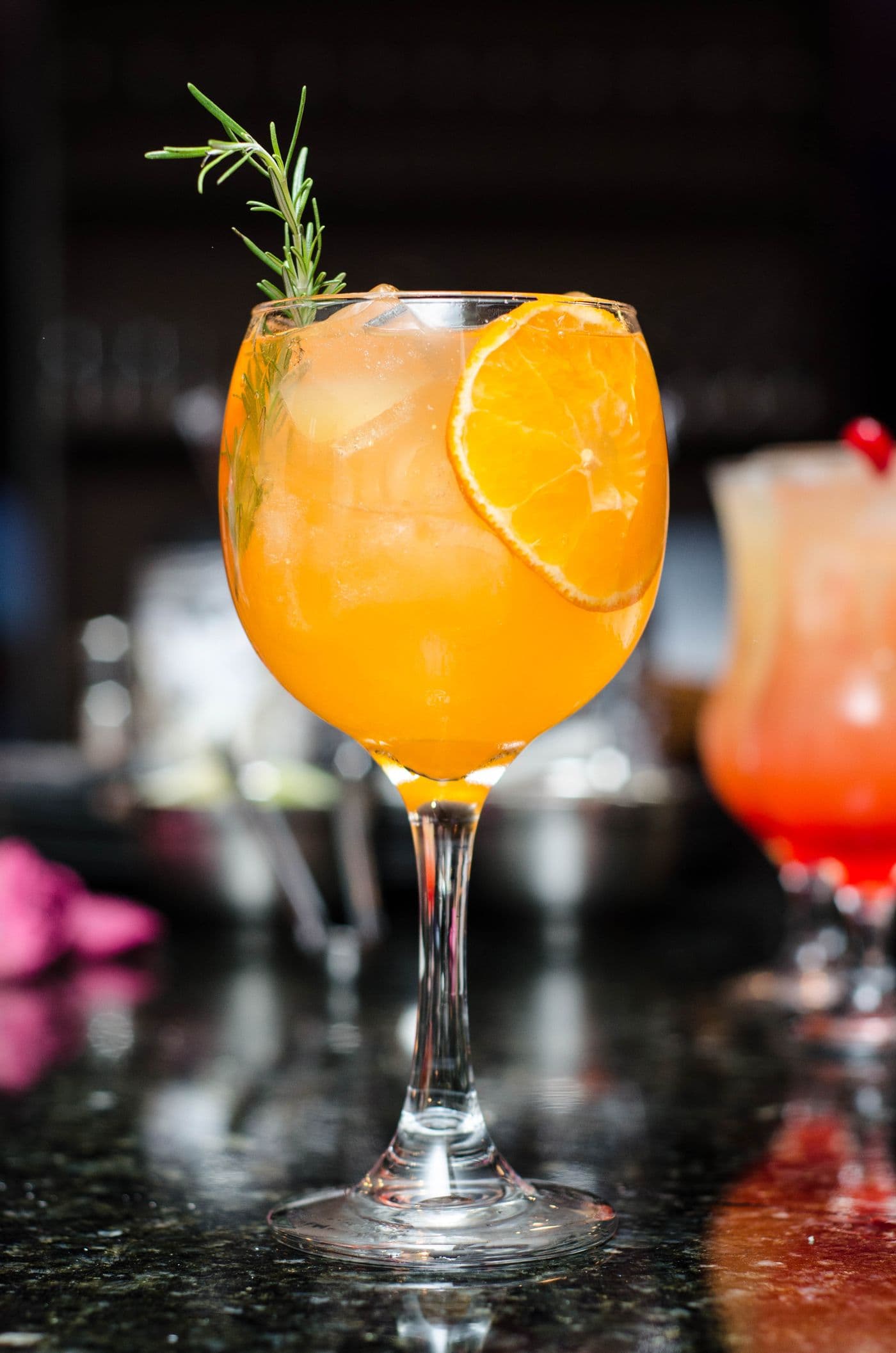 Stock photograph of a citrus drink with orange and rosemary
