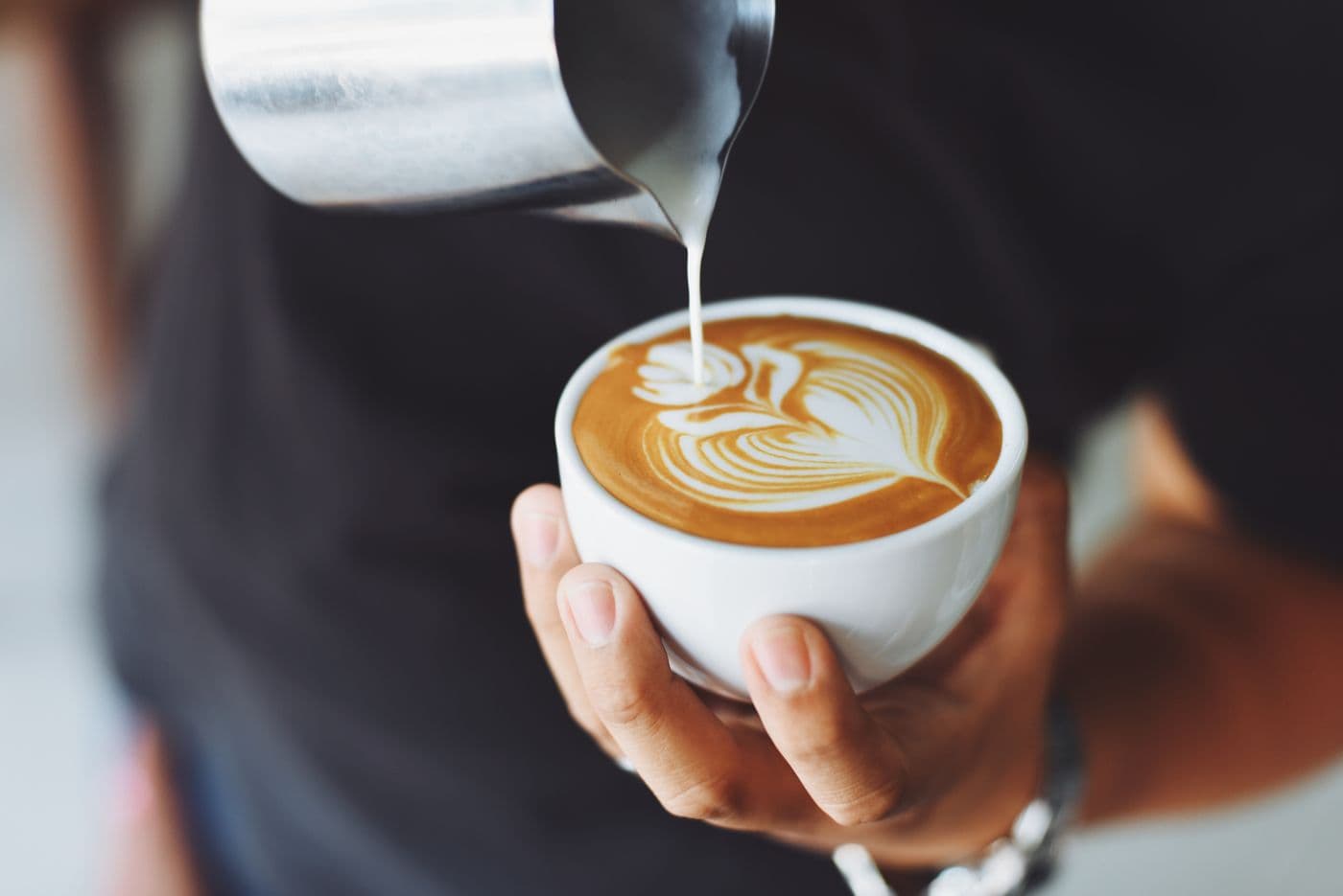 Stock photograph of a barista pouring a coffee