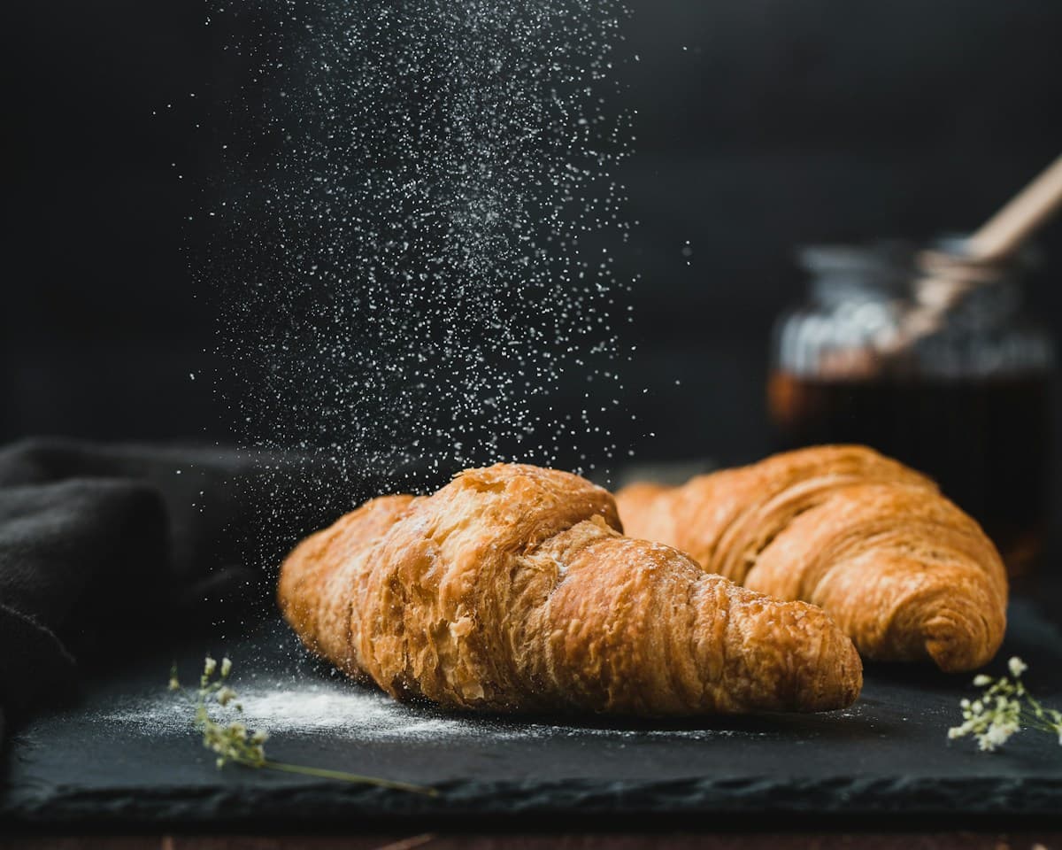 Stock photograph of golden croissants dusted with sugar